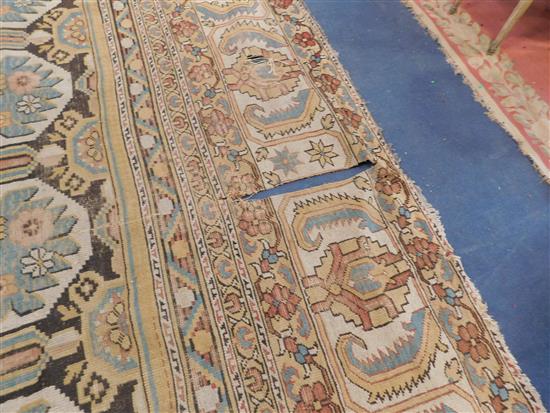 A large Indian carpet, circa 1910, 16ft 1in x 21ft 4in. (652cm x 491cm), fragment 5ft 11in. x 3ft 6in.